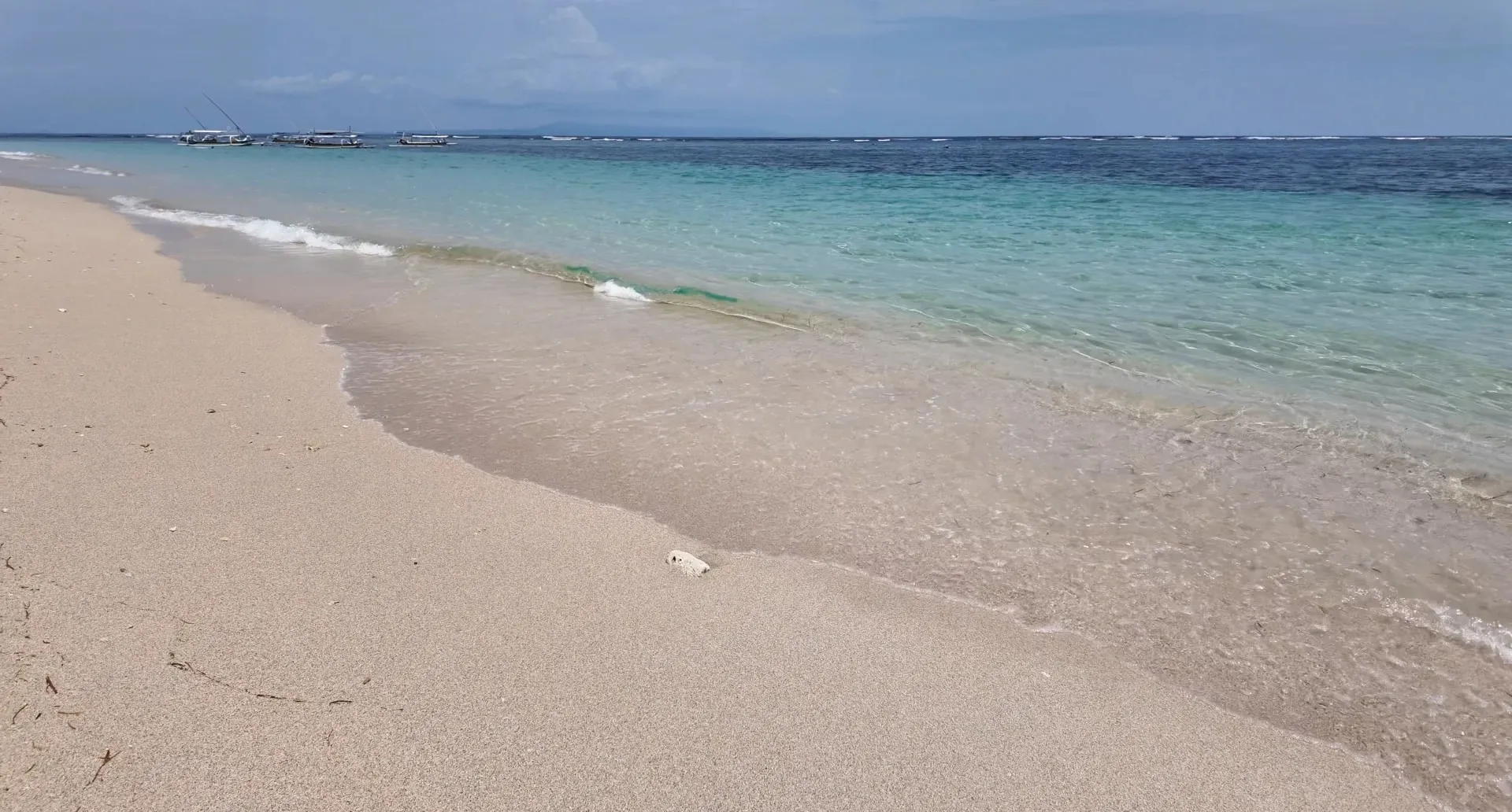 White sand and clear, calm water on the beach at the St. Regis