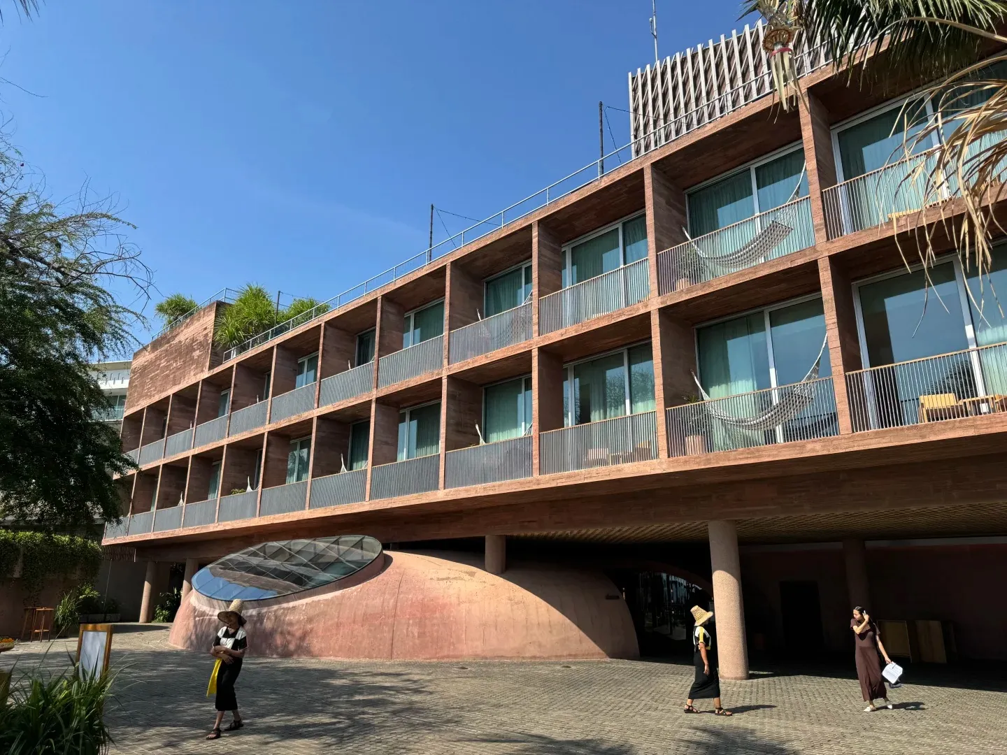 The red-brick hotel wing, raised on pillars over the courtyard