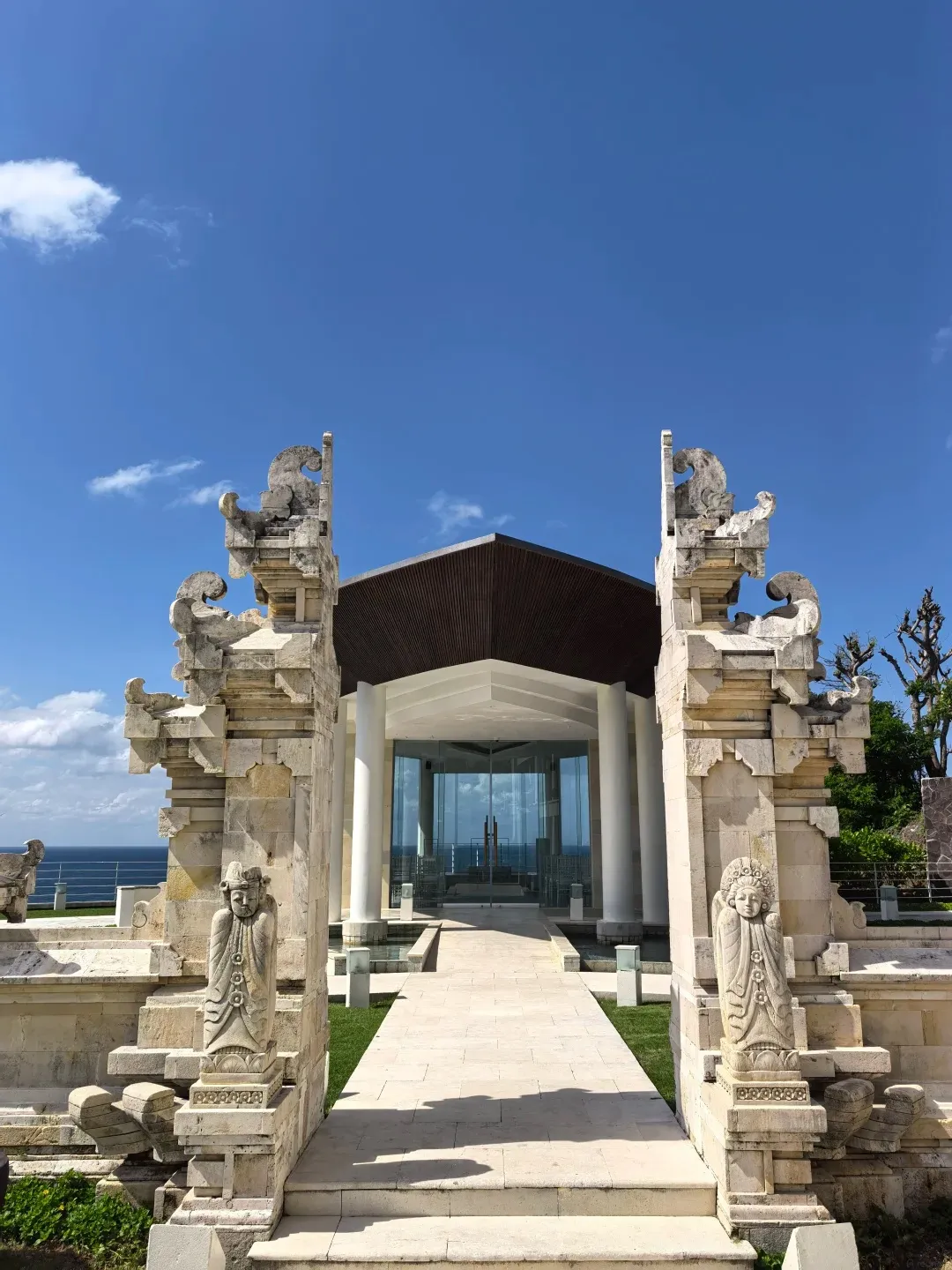 A carved Balinese split gate leading to the lobby