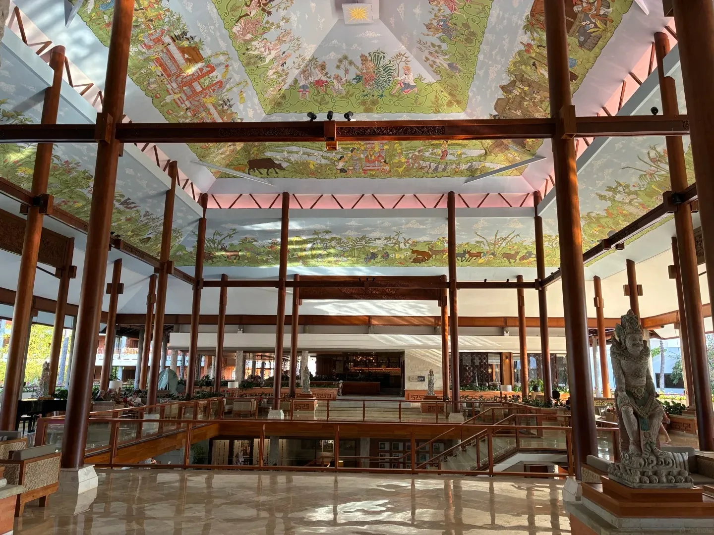 The open-sided lobby pavilion under a painted ceiling