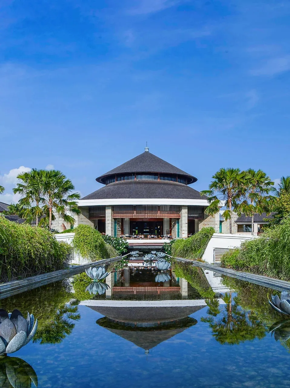The lobby pavilion reflected in a long pond