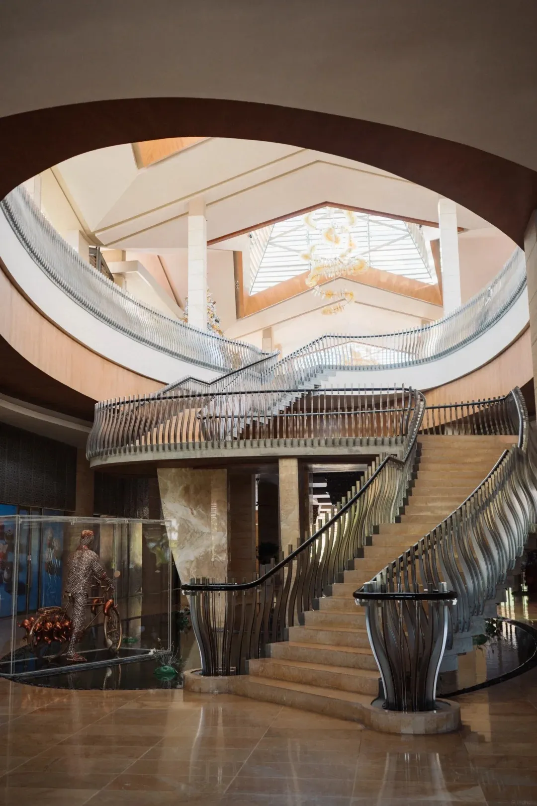 A sweeping staircase under a domed skylight in the lobby