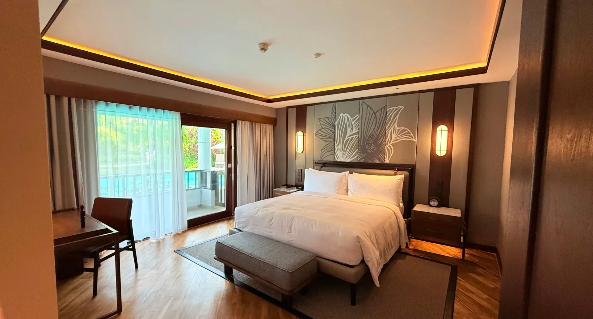 A guest room at The Laguna with a king bed and a balcony over the pool