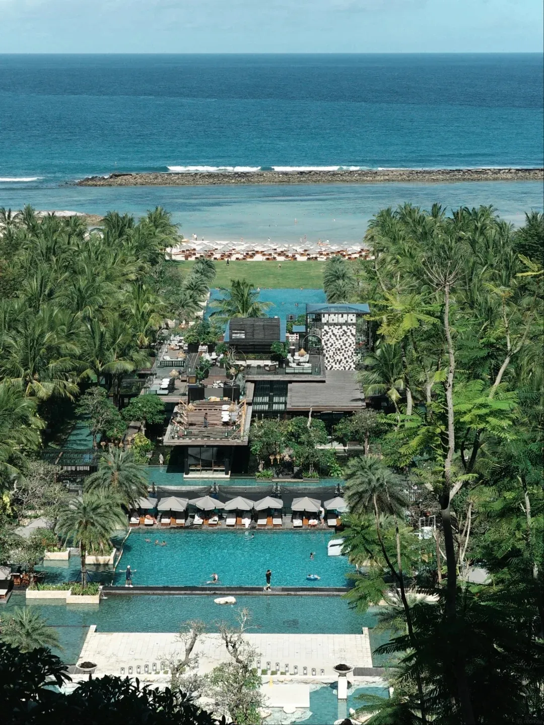 Terraced pools and gardens stepping down the hillside to the sea